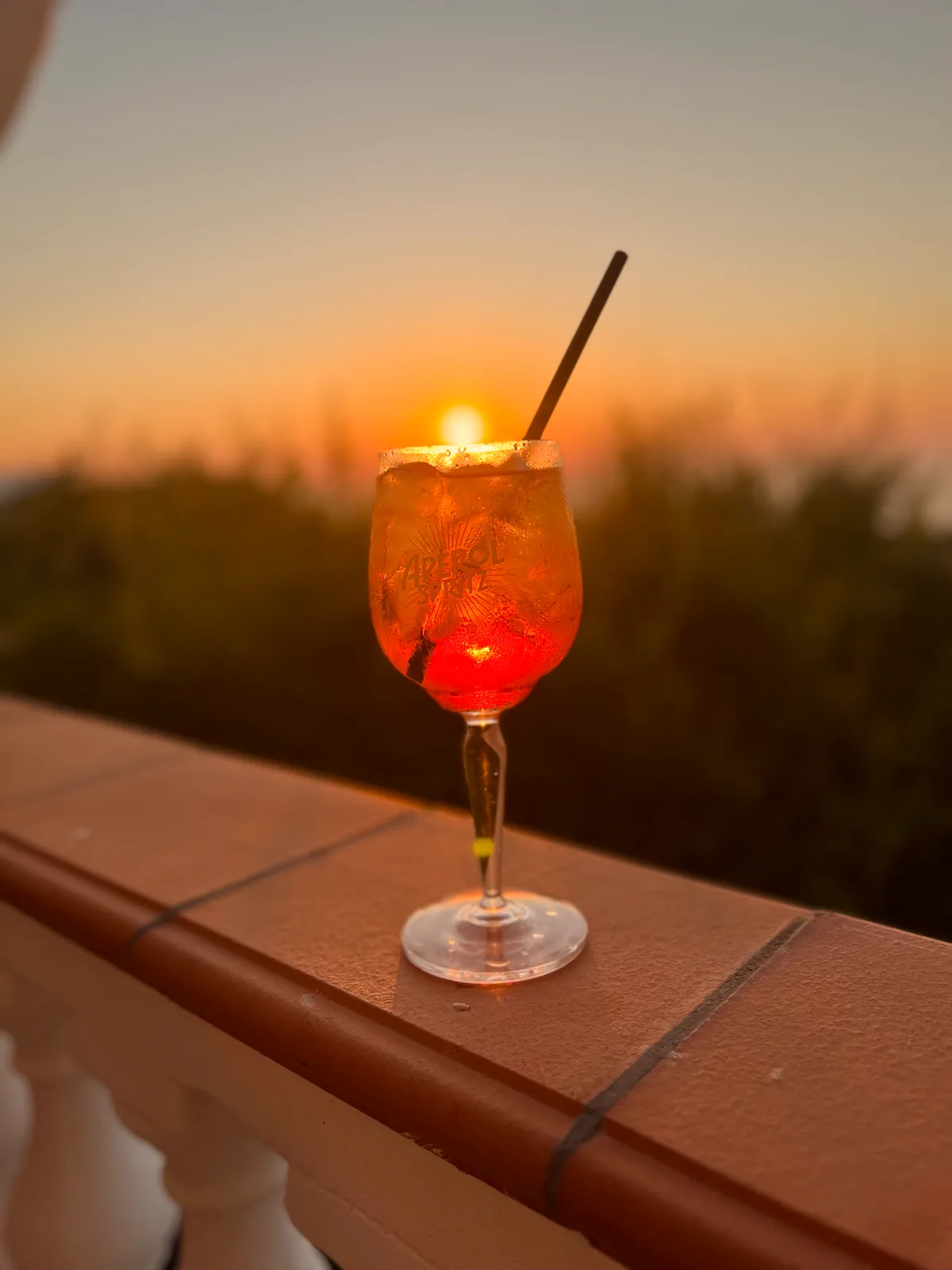 Aperol Spritz on a Calabrian terrace as the sun sets over the coast